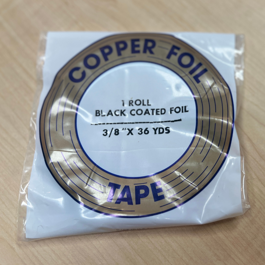 A roll of EDCO black back copper foil tape, 3/8 inch wide and 36 yards long, packaged in clear plastic.